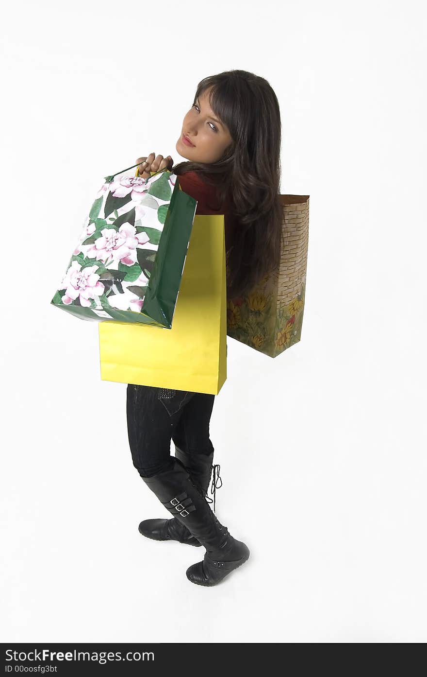 Pretty young woman with green yellow and beige shopping bags. Pretty young woman with green yellow and beige shopping bags