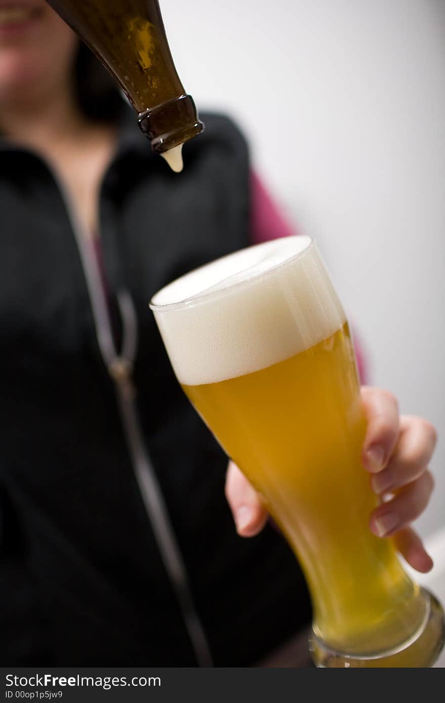 A delicious glass of german Wheat-beer (Weizenbier) is poured in. A delicious glass of german Wheat-beer (Weizenbier) is poured in