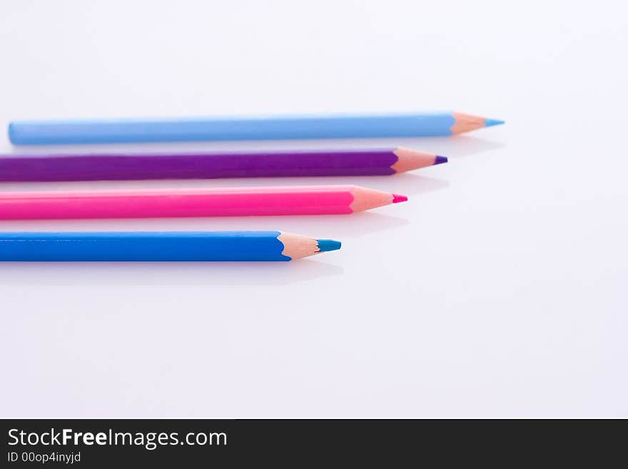 Wooden colored crayons isolated on white background