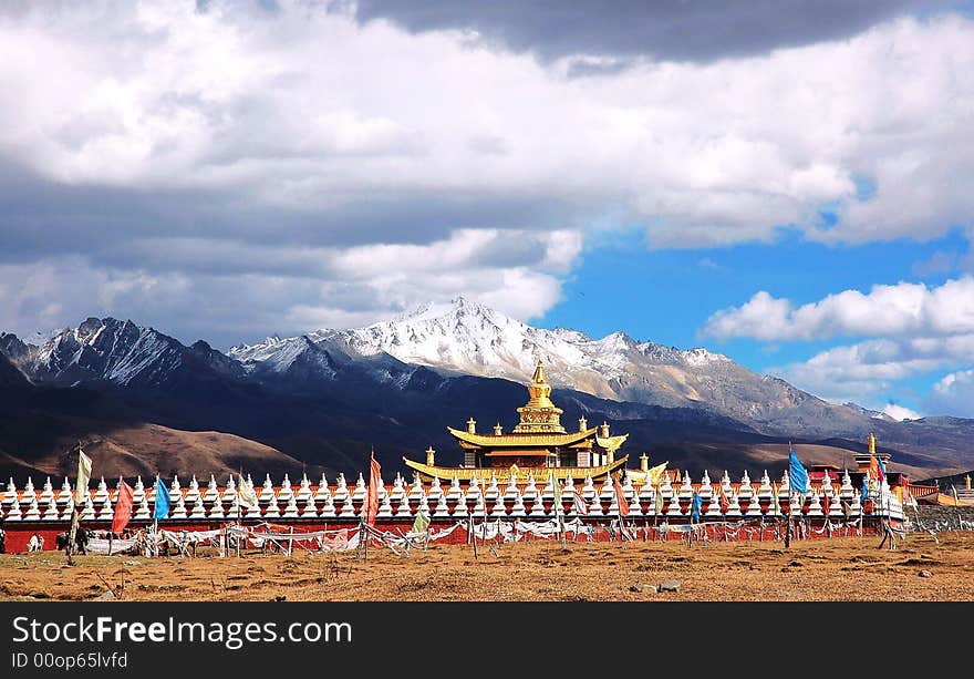 Jokul and Temple. A golden tower in a temple. The temple is at the foot of a Jokul.