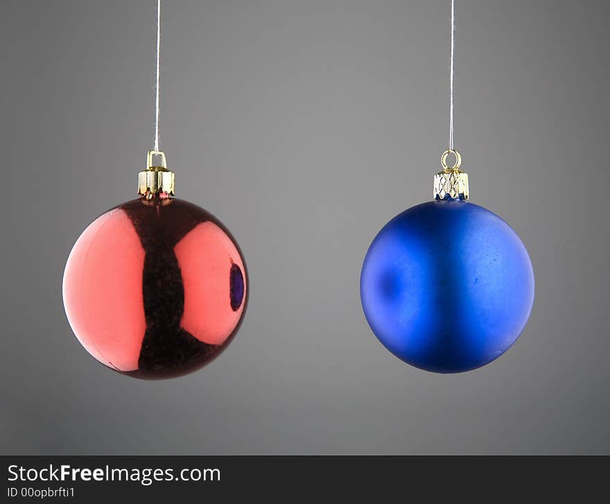 Red and Blue Christmas Baubles against Grey Background. Red and Blue Christmas Baubles against Grey Background