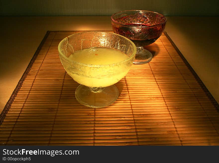 Red jam and yellow honey on the table. Red jam and yellow honey on the table