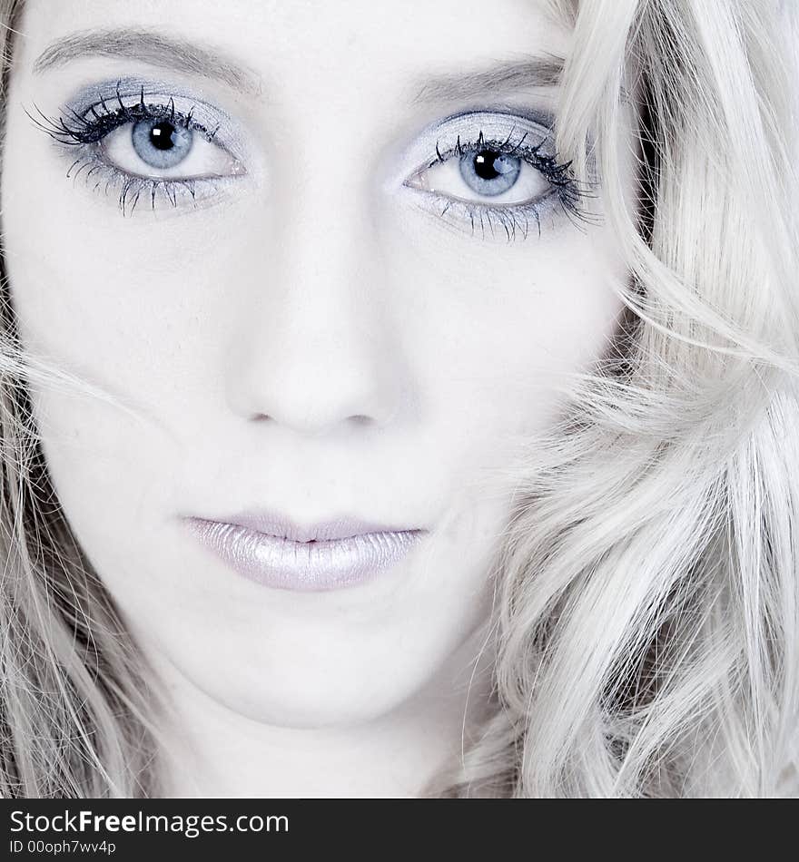 Studio portrait of a long blond girl looking hurt