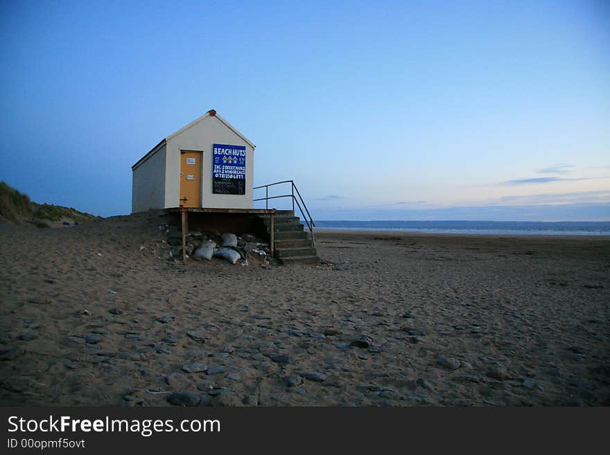 A beach hut alone on a beach