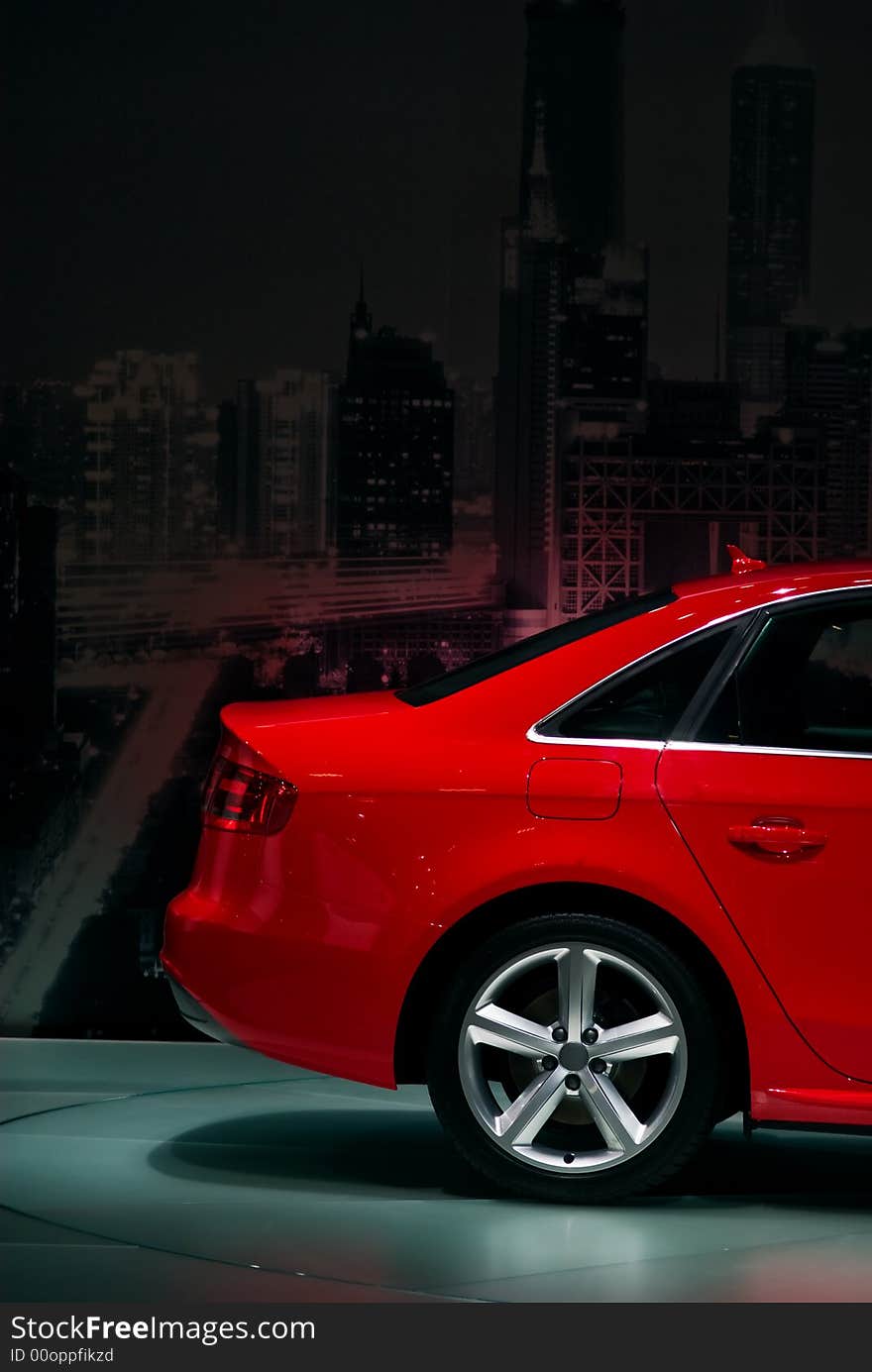 This photo could be an ads for urban trasport. A red car on a cityscape background. This photo could be an ads for urban trasport. A red car on a cityscape background