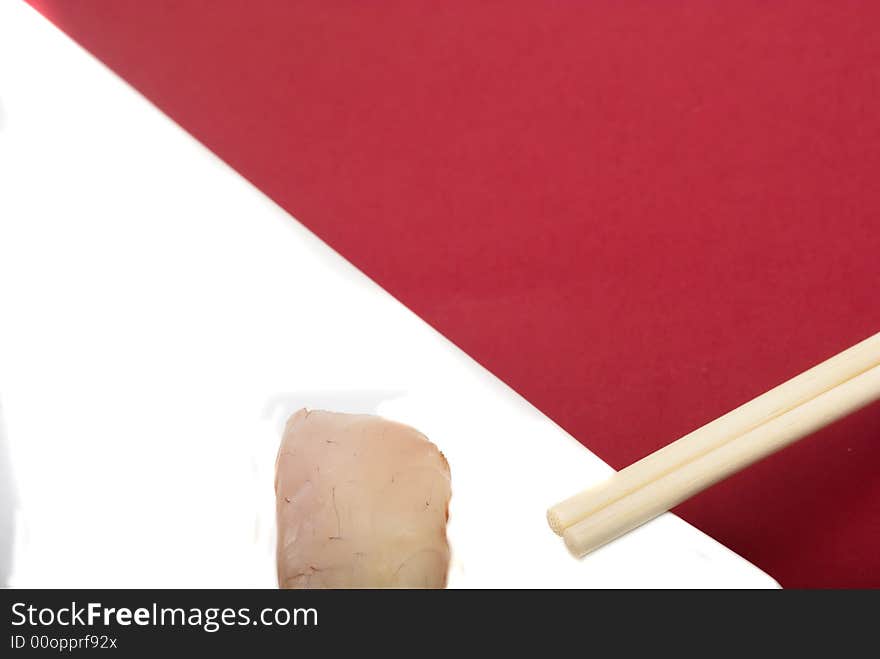 Sushi crude fish on a white plate over a reddish background