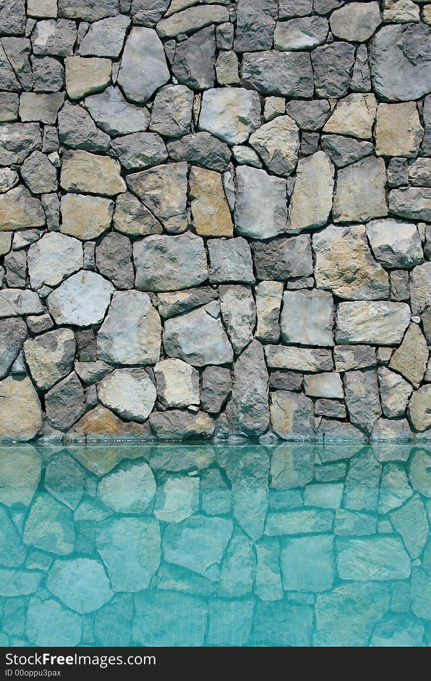 Swimming pool wall reflected on the water