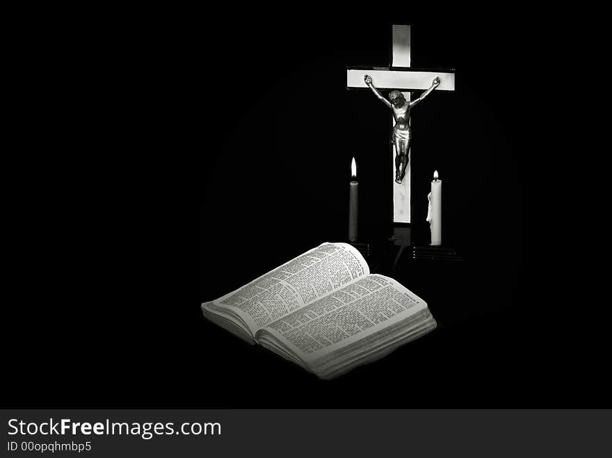 Stark black and white image of a prayer crucifix with two candles set out before a bible open to the book of Jeremiah. Stark black and white image of a prayer crucifix with two candles set out before a bible open to the book of Jeremiah