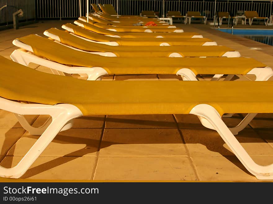 Row of sunbeds by the pool