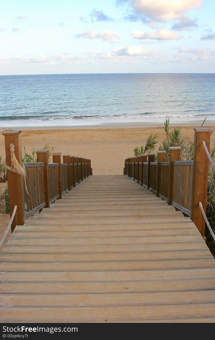 Stairway to the beach with the sea on background