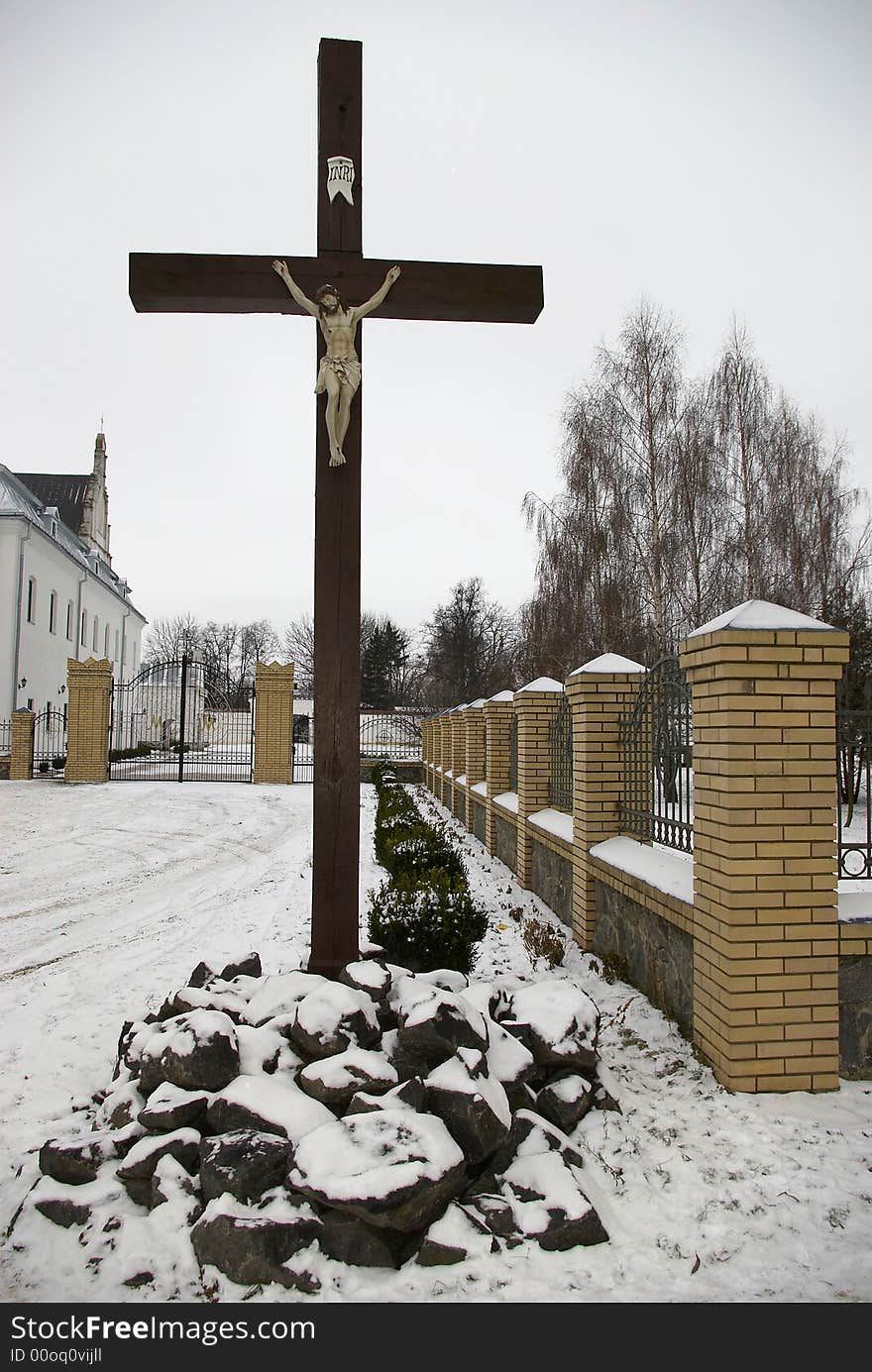 Wooden cross on road before a church. Wooden cross on road before a church