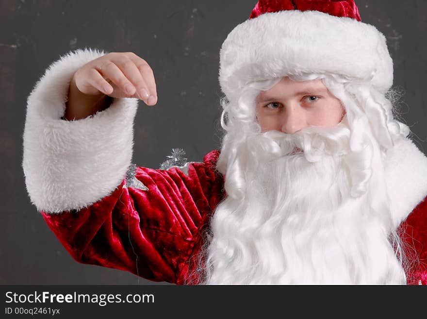 Santa Claus showing onto a red mitten. Santa Claus showing onto a red mitten