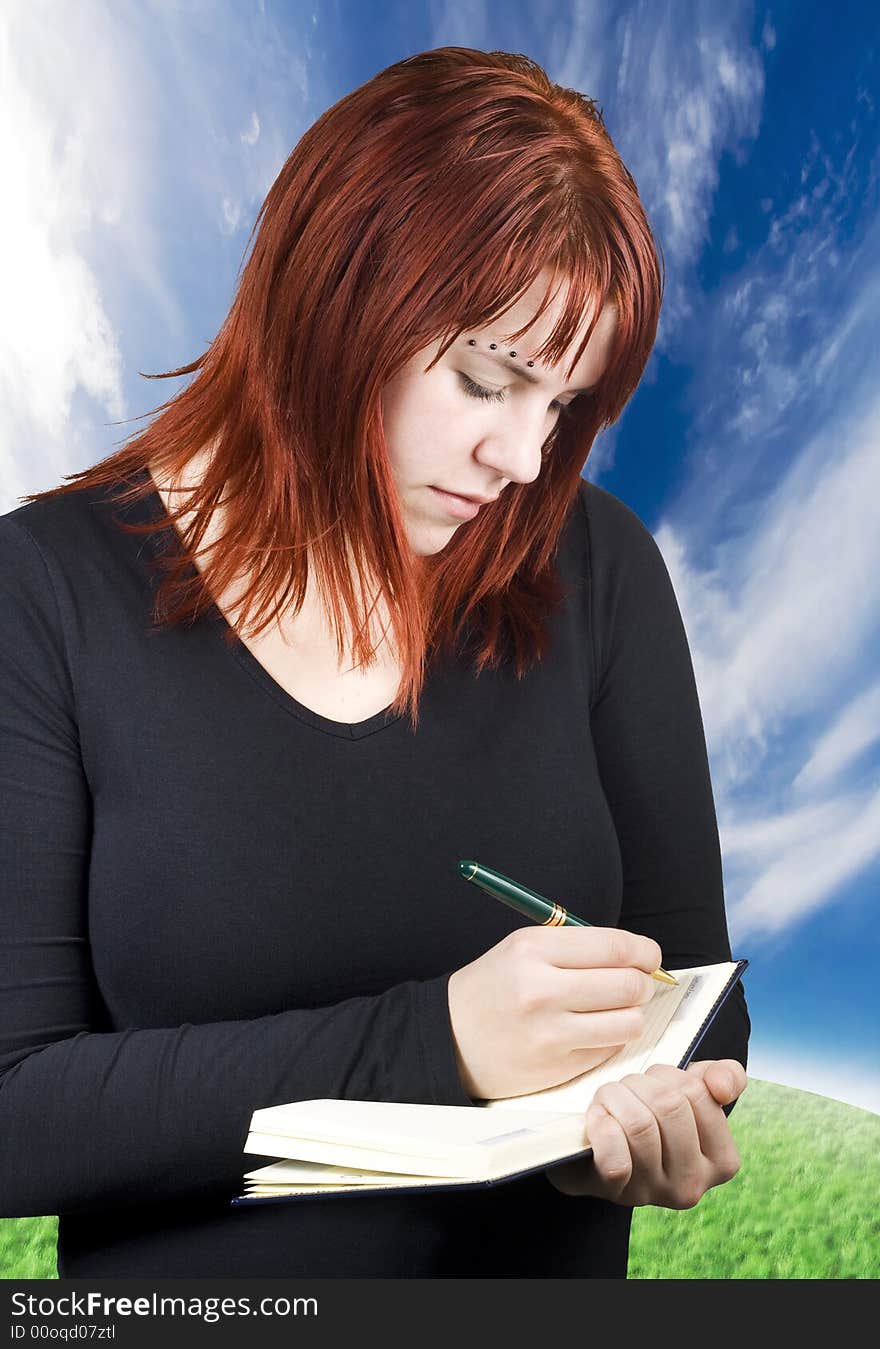 Cute Redhead Writing In Her Notebook Or Diary