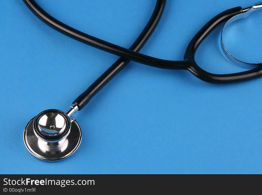 A stethoscope in plain blue background.