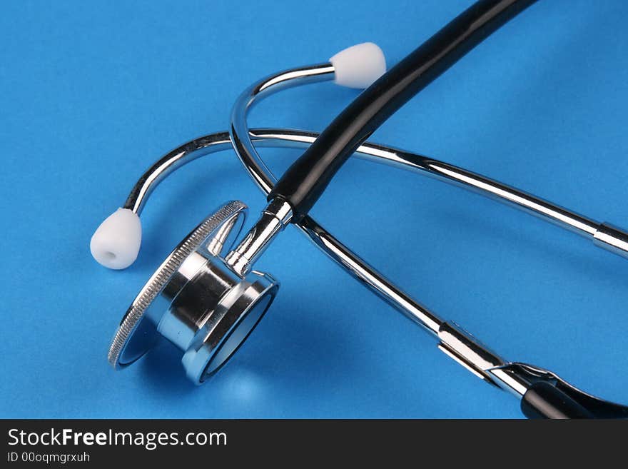 A stethoscope in plain blue background.