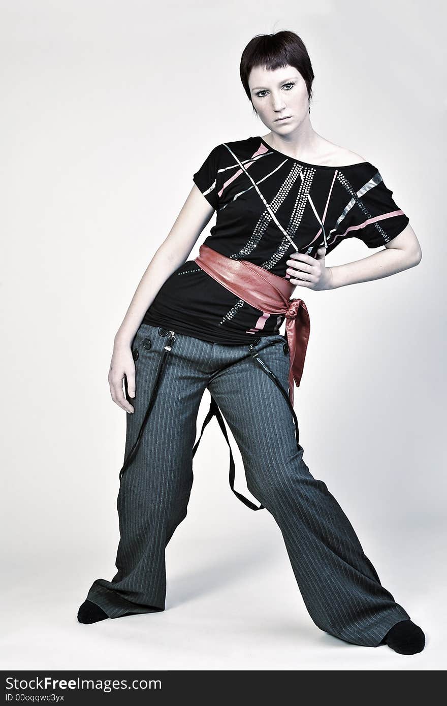 Studio portrait of a young woman with short hair looking fashionable. Studio portrait of a young woman with short hair looking fashionable