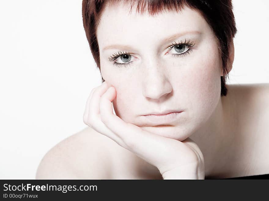 Studio Portrait Of A Bored Young Woman With Short