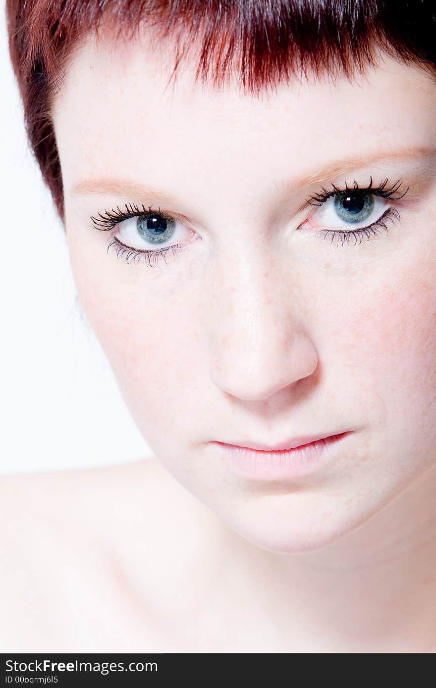 Studio portrait of a young woman with short hair making eye contact