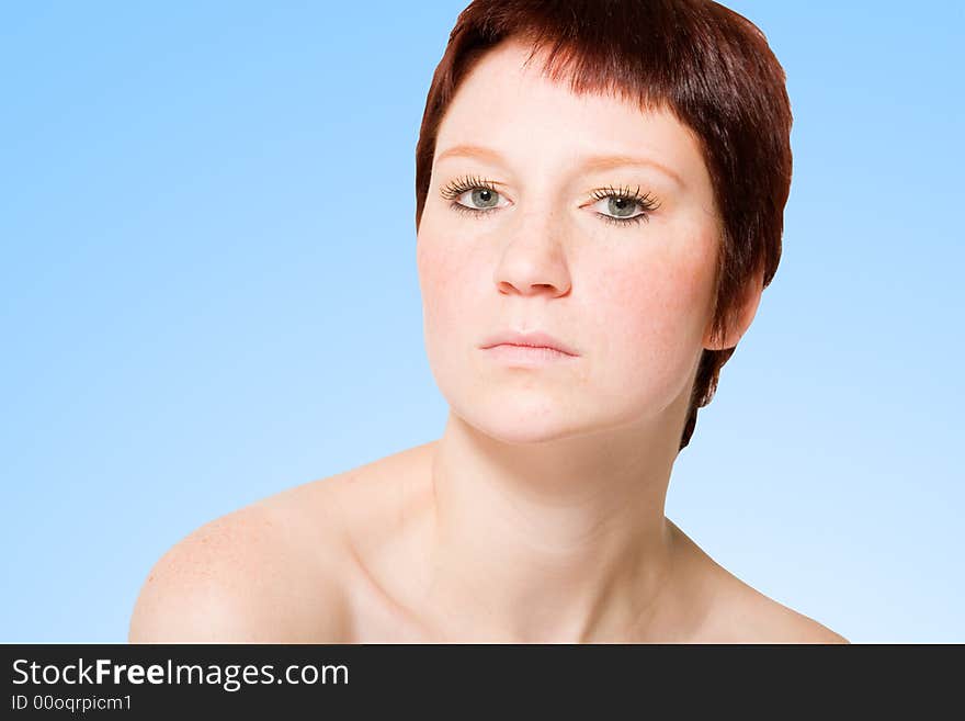 Studio portrait of a young woman with short hair looking uptight. Studio portrait of a young woman with short hair looking uptight