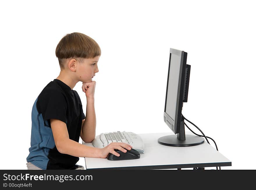Boy on computer with cordless mouse and keyboard thinking. Boy on computer with cordless mouse and keyboard thinking.