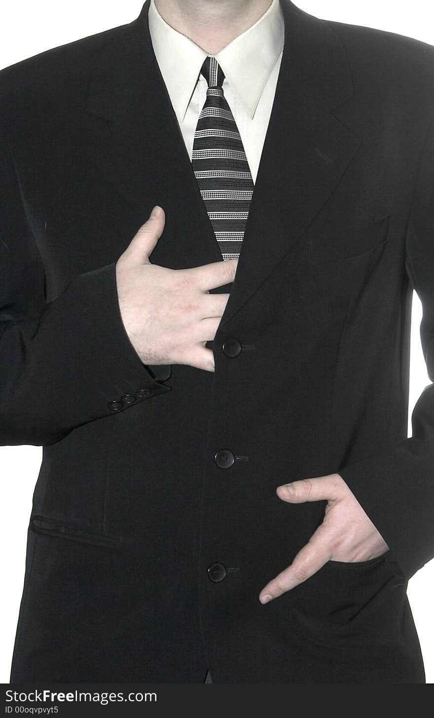 Young businessman stands expectant, fold arms on white background