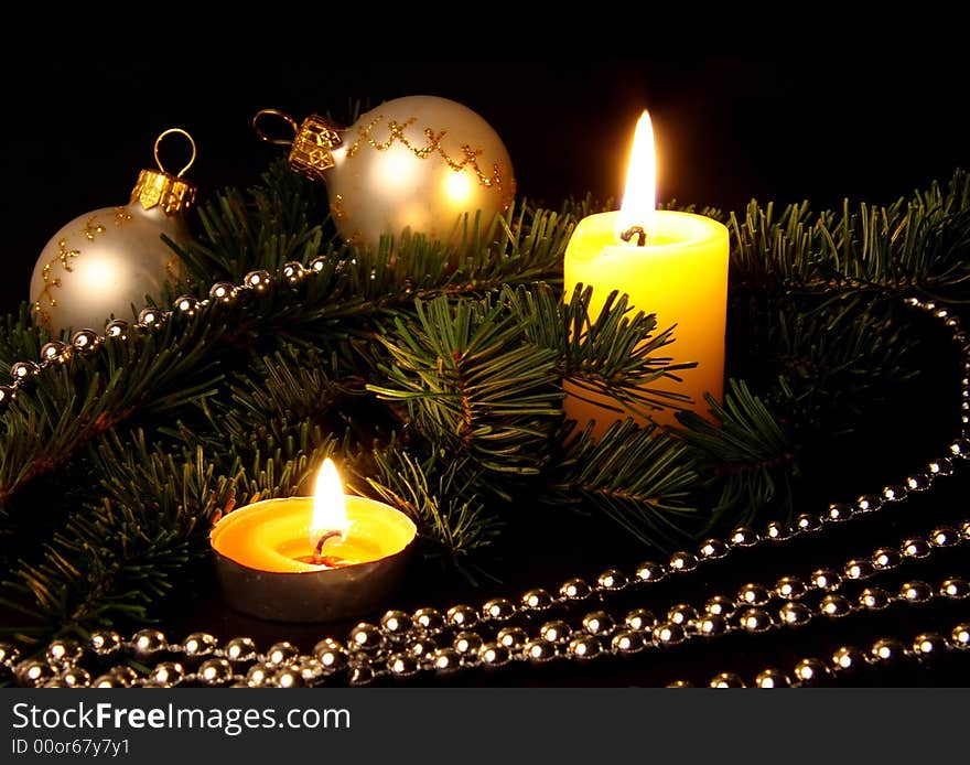 The christmas decor will consist of fir branches, candles, spheres and a beads. Dark background. The christmas decor will consist of fir branches, candles, spheres and a beads. Dark background.