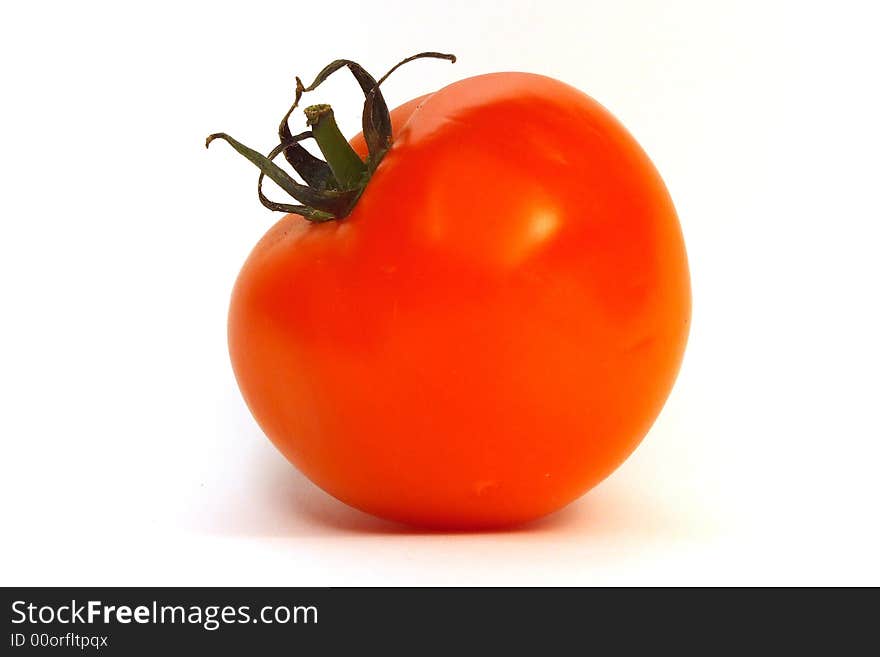 Fruit of red tomato against a white background