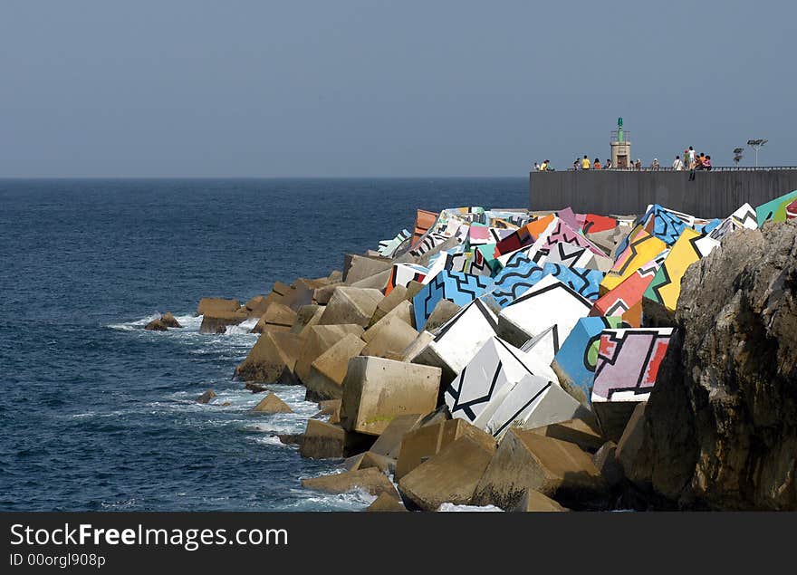 A great peaces of stone on a seaside built to break waves. A great peaces of stone on a seaside built to break waves