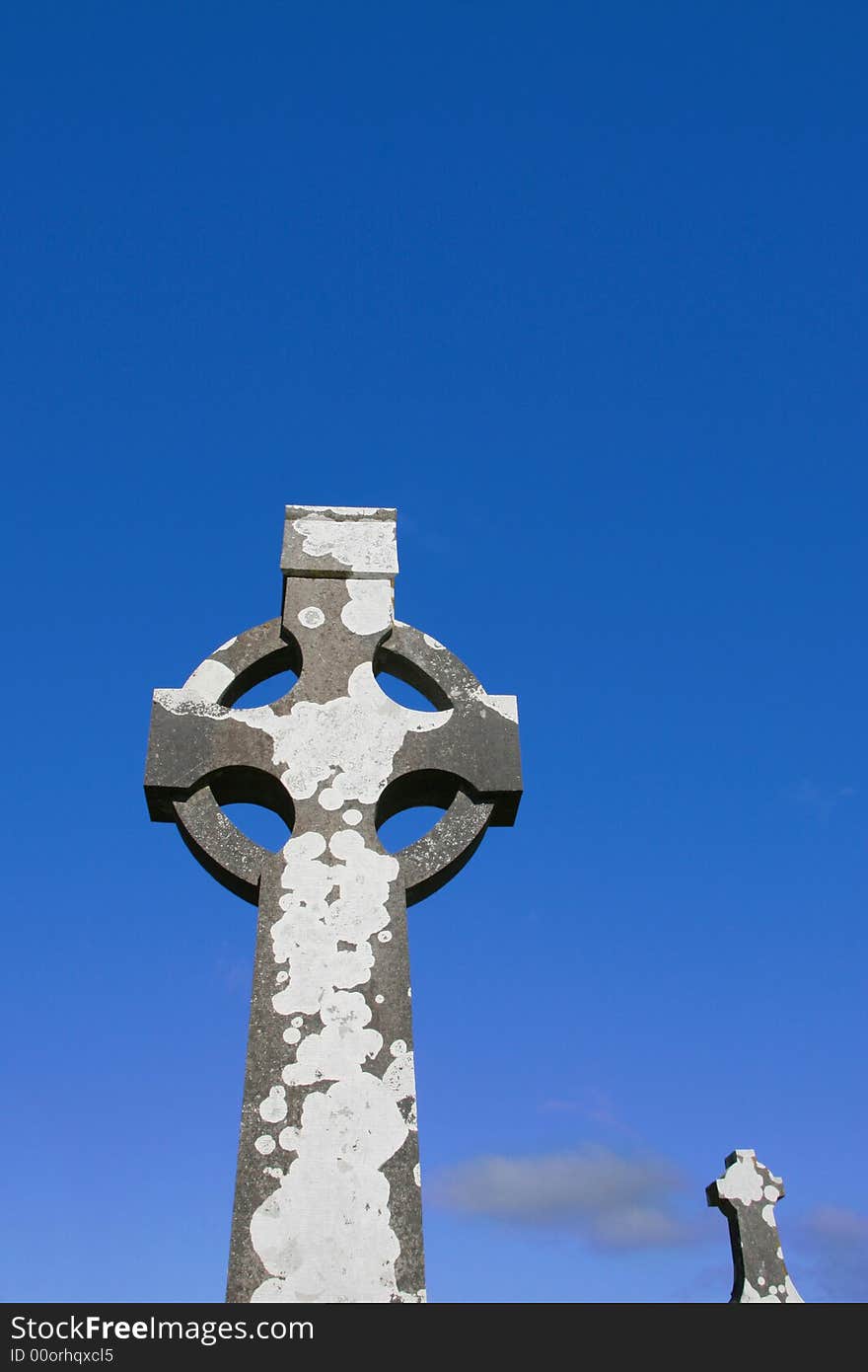 A celtic cross in an irish graveyard. A celtic cross in an irish graveyard