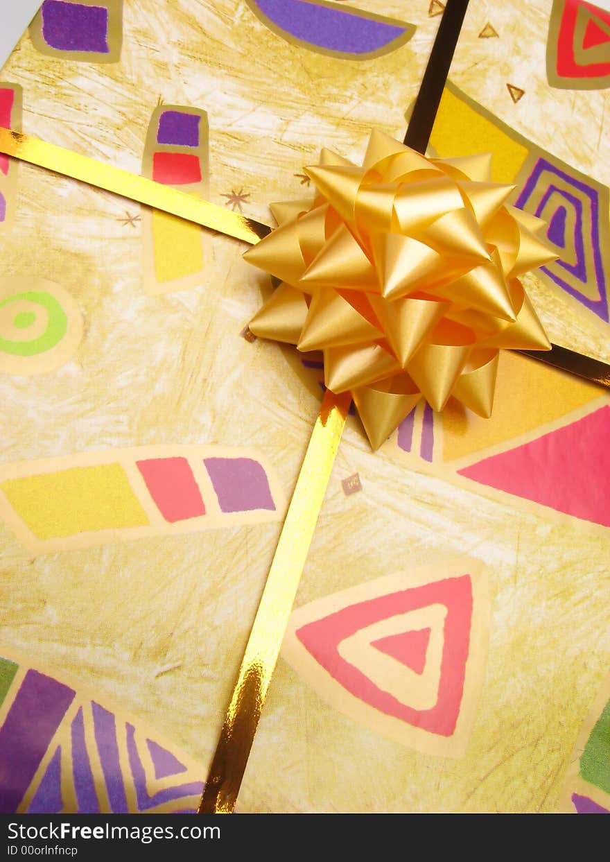 Gift in box packed into bright color paper , close up