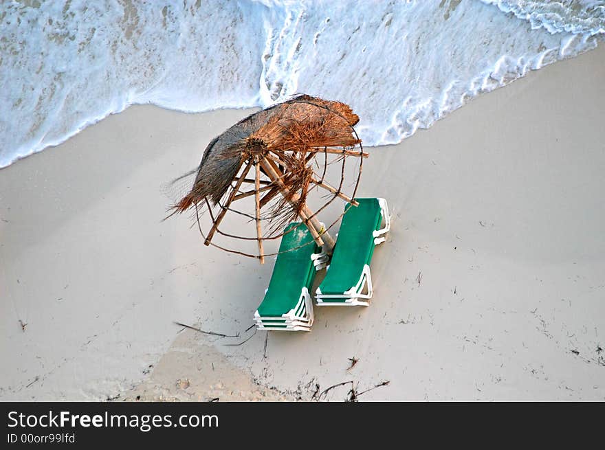 A view of ocean ,beach and broken umbrellas. A view of ocean ,beach and broken umbrellas