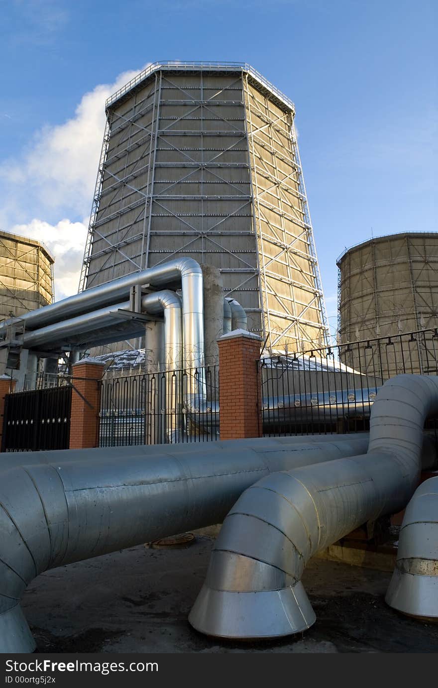 Electric power station chimneys over blue sky