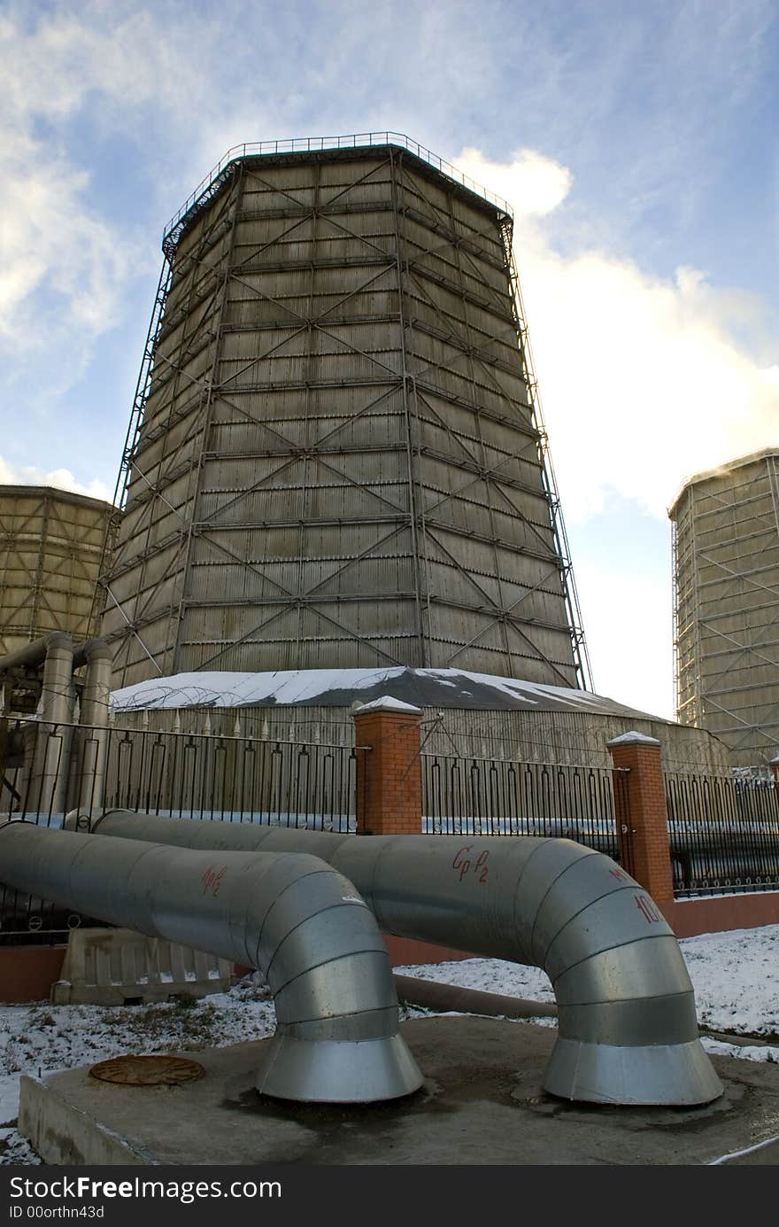 Electric power station chimneys over blue sky