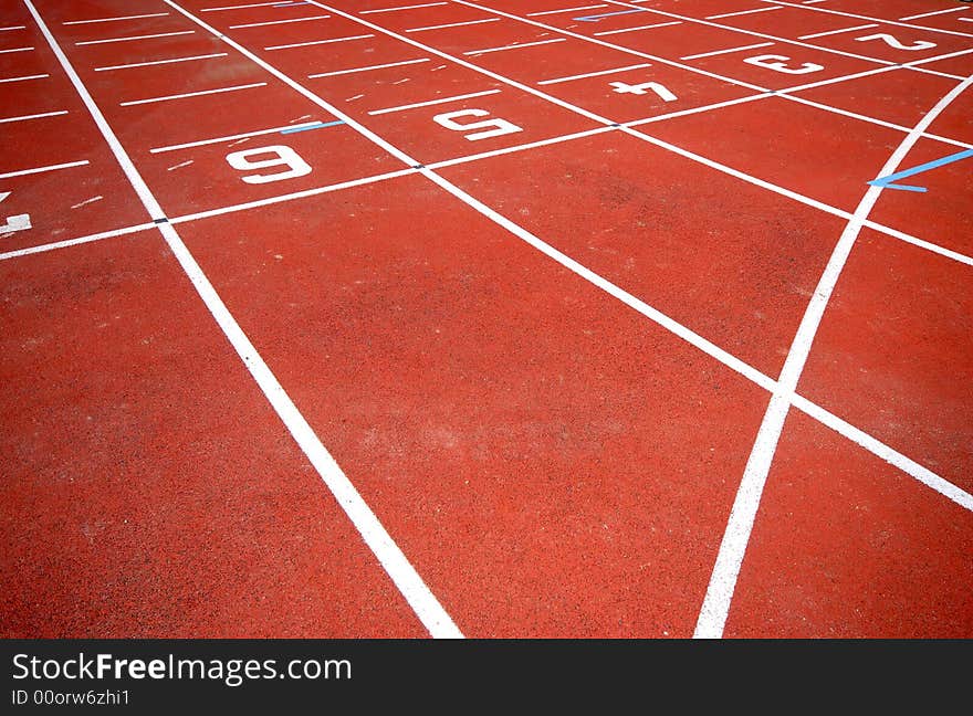Numbers of a racetrack, on red tarmac, for runners. Numbers of a racetrack, on red tarmac, for runners