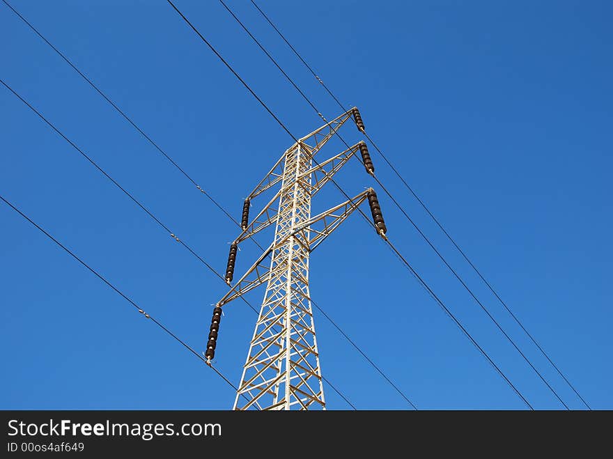 Electrical tower on a background of the blue sky. Electrical tower on a background of the blue sky