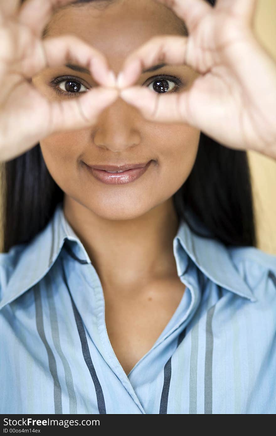 Businesswoman looking through her fingers