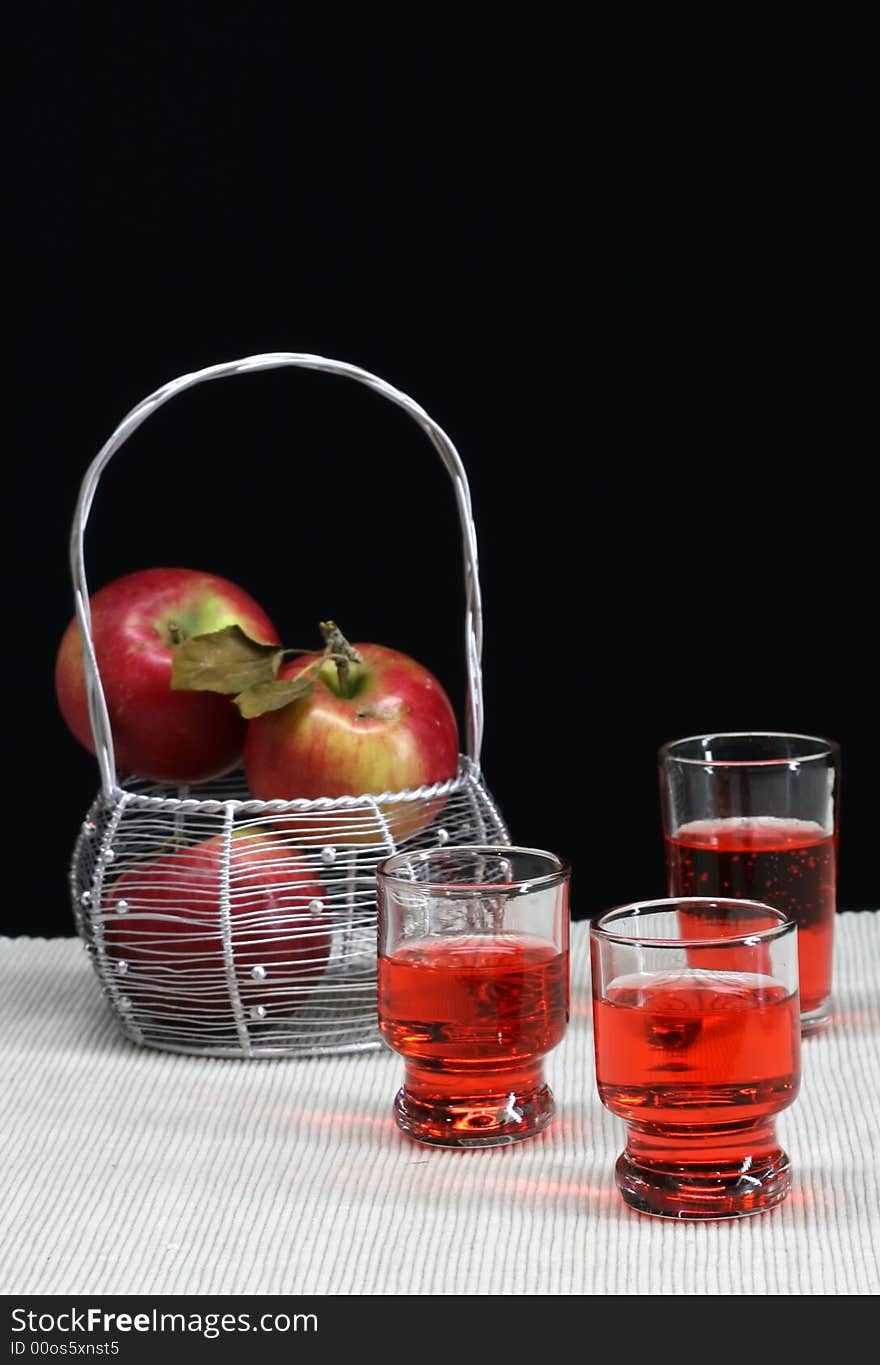 A basket of apple and fresh apple  cider. A basket of apple and fresh apple  cider