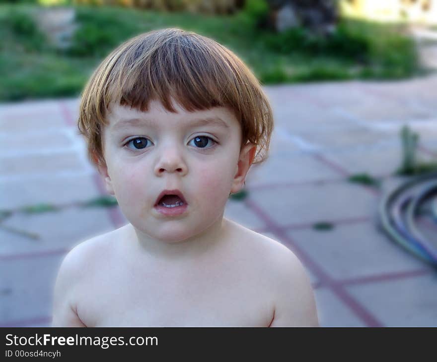 Young boy with dirty open mouth waiting for more ice cream. Young boy with dirty open mouth waiting for more ice cream