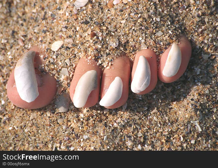 Sea sand and stones on toe-nails. Sea sand and stones on toe-nails