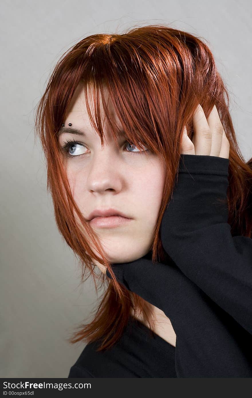 Cute redhead with messy hair looking away