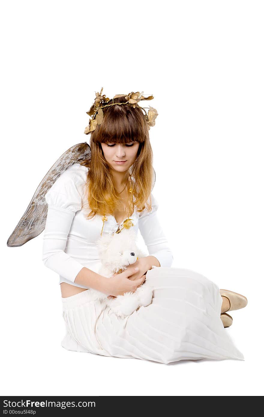 Angel girl sitting and holding teddy bear isolated on white. Angel girl sitting and holding teddy bear isolated on white