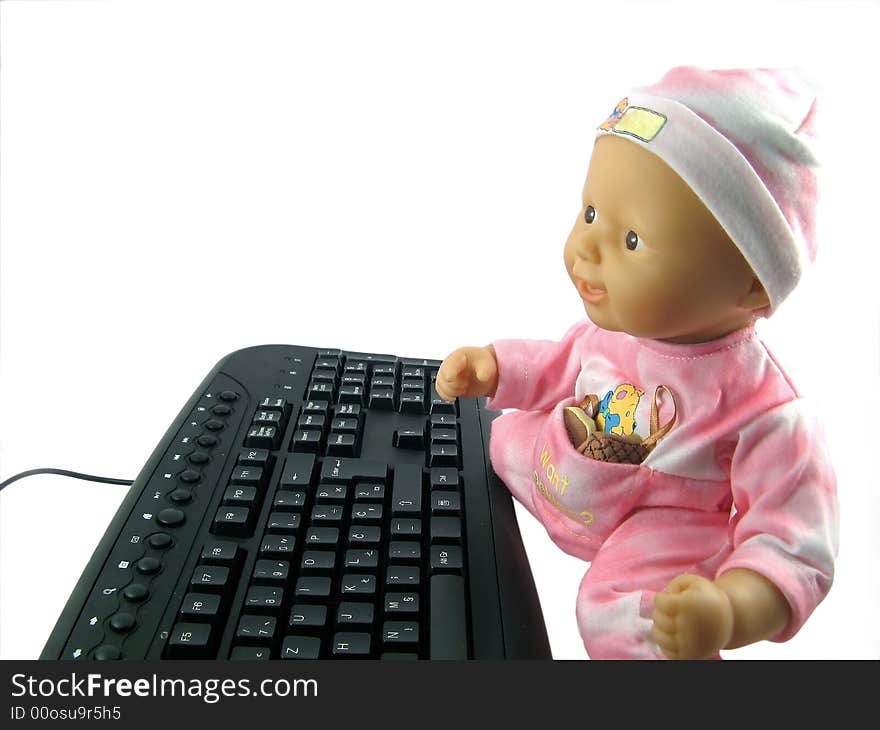 Baby doll and black keyboard. Baby doll and black keyboard