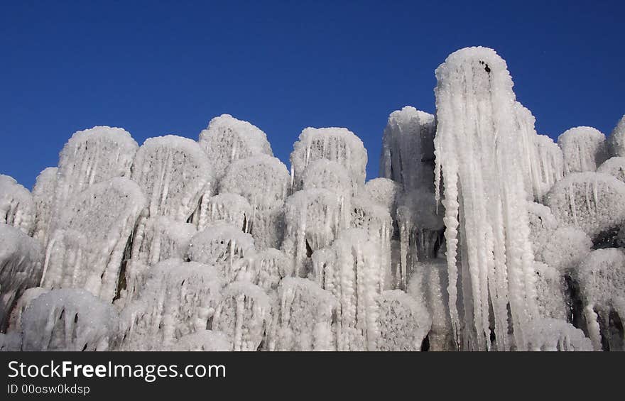 Icicles hanging at tree logs