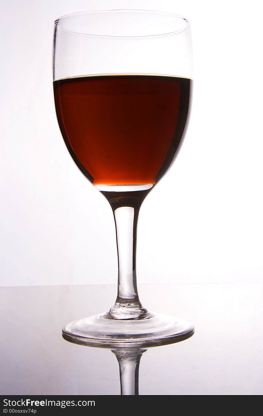 A glass of red wine in white background.