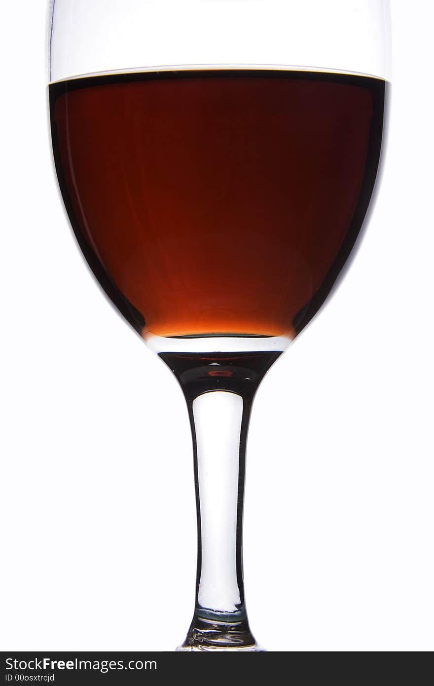 Close up of a glass of red wine in white background.