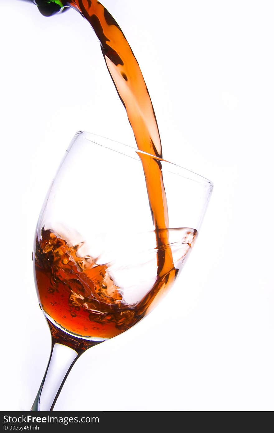 Pouring the red wine into the wineglass in white background. Pouring the red wine into the wineglass in white background.