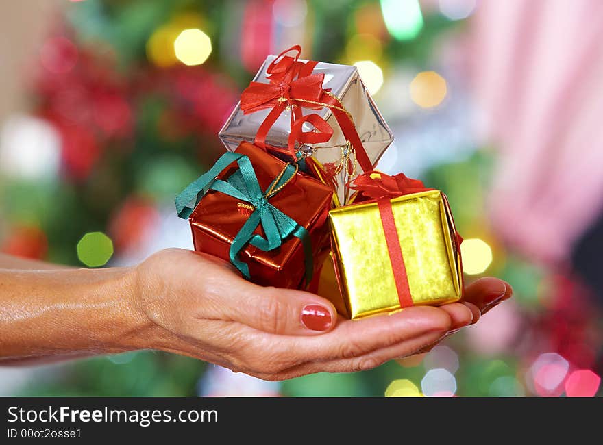 View of nice Christmas gifts  in gold color cover on hand