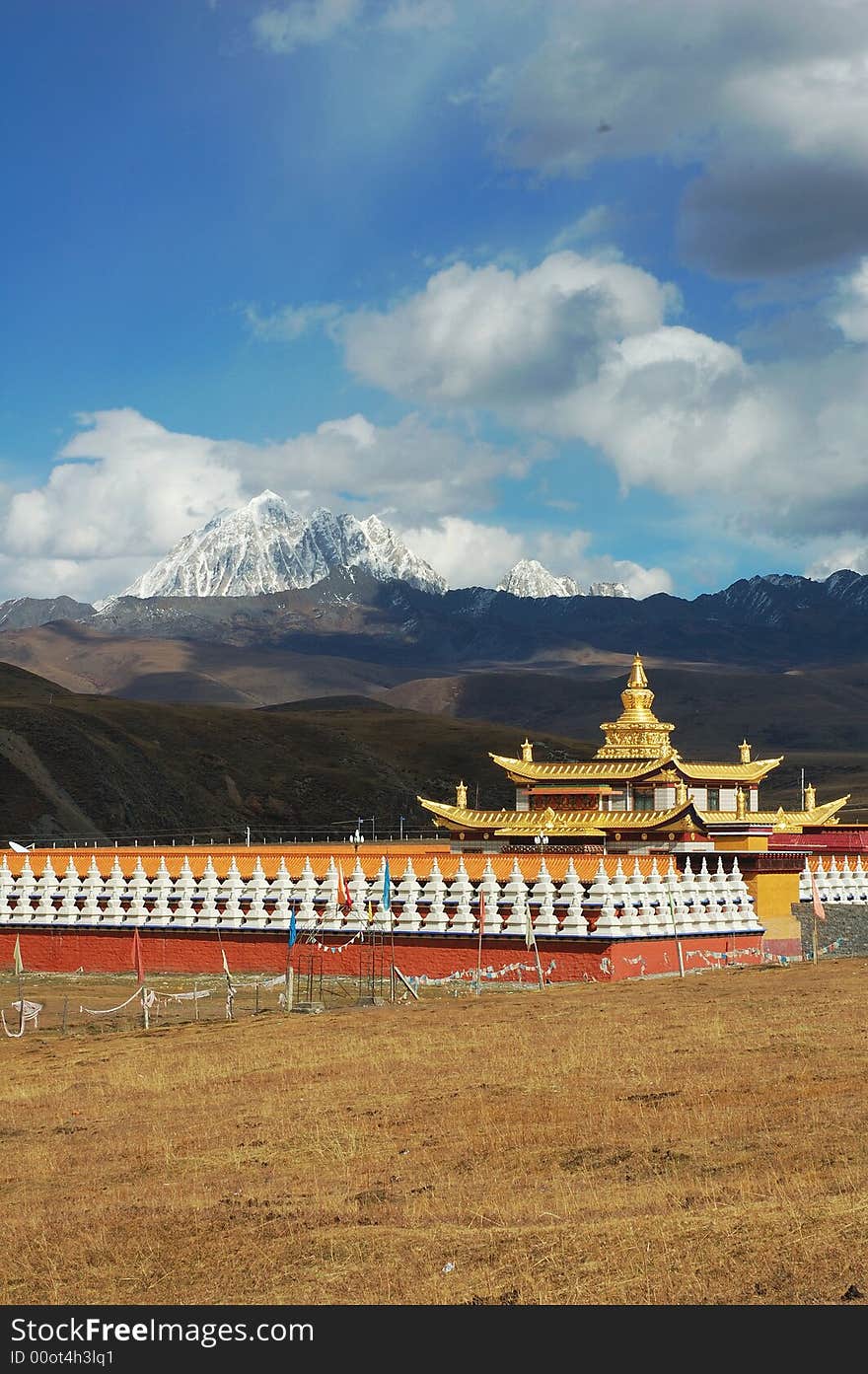 Jokul and Temple. A golden tower in a temple. The temple is at the foot of a Jokul.