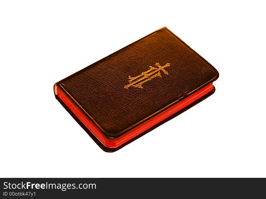 A black bible sits isolated on a white background.