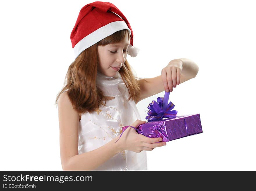 The girl in a white dress and a red hat, holds gifts in hands